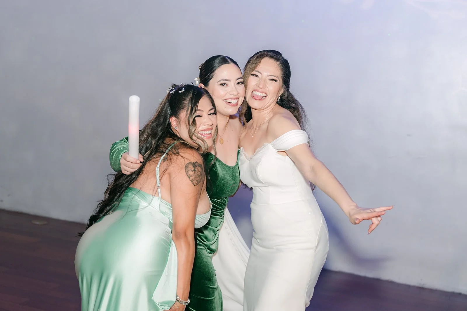Mariana dancing with bridesmaids holding glow sticks
