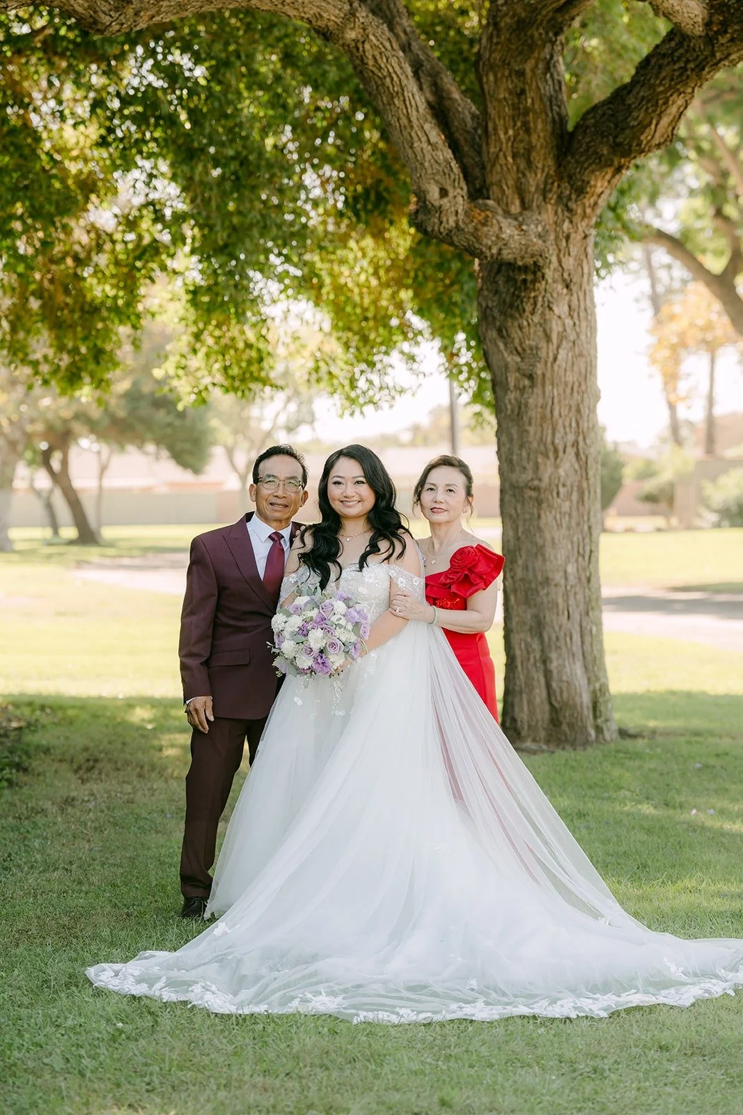Jennifer and Kevin with family members on the lawn, photographed by One and Only Production