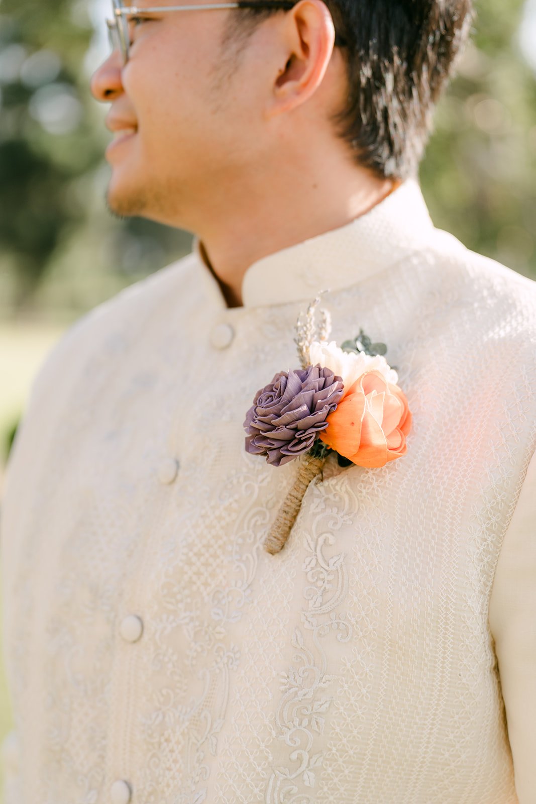A close detail of Jacob's boutonniere and barong