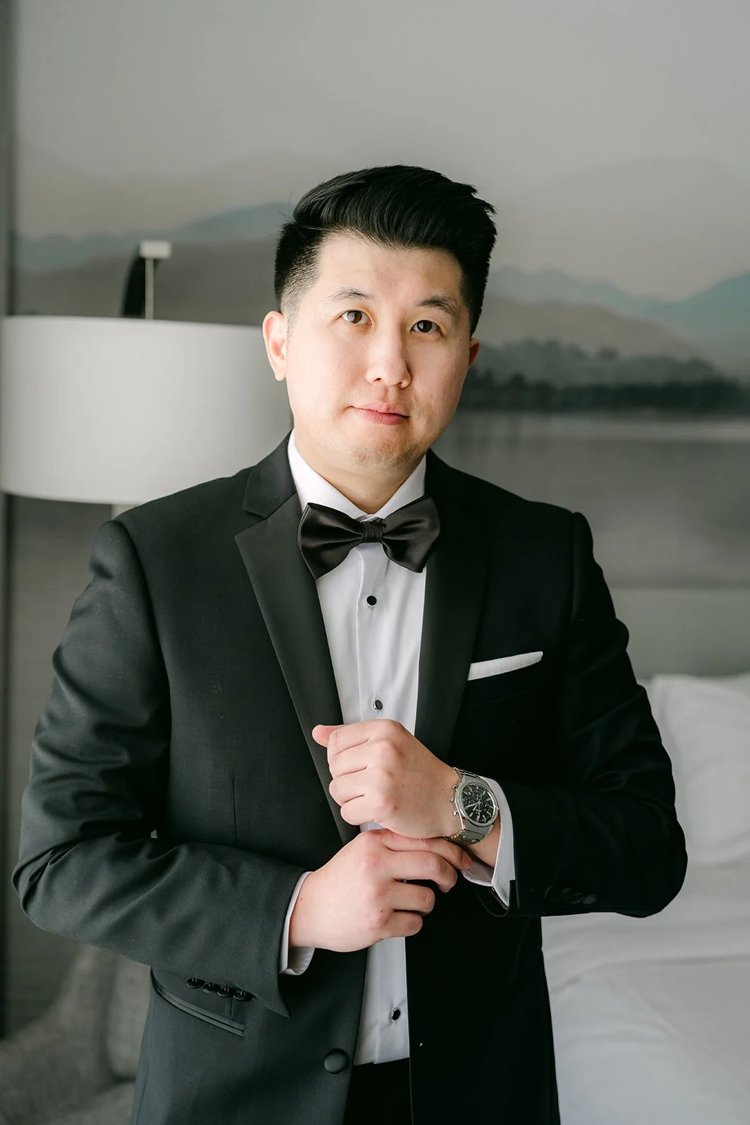 San buttoning his tuxedo jacket.