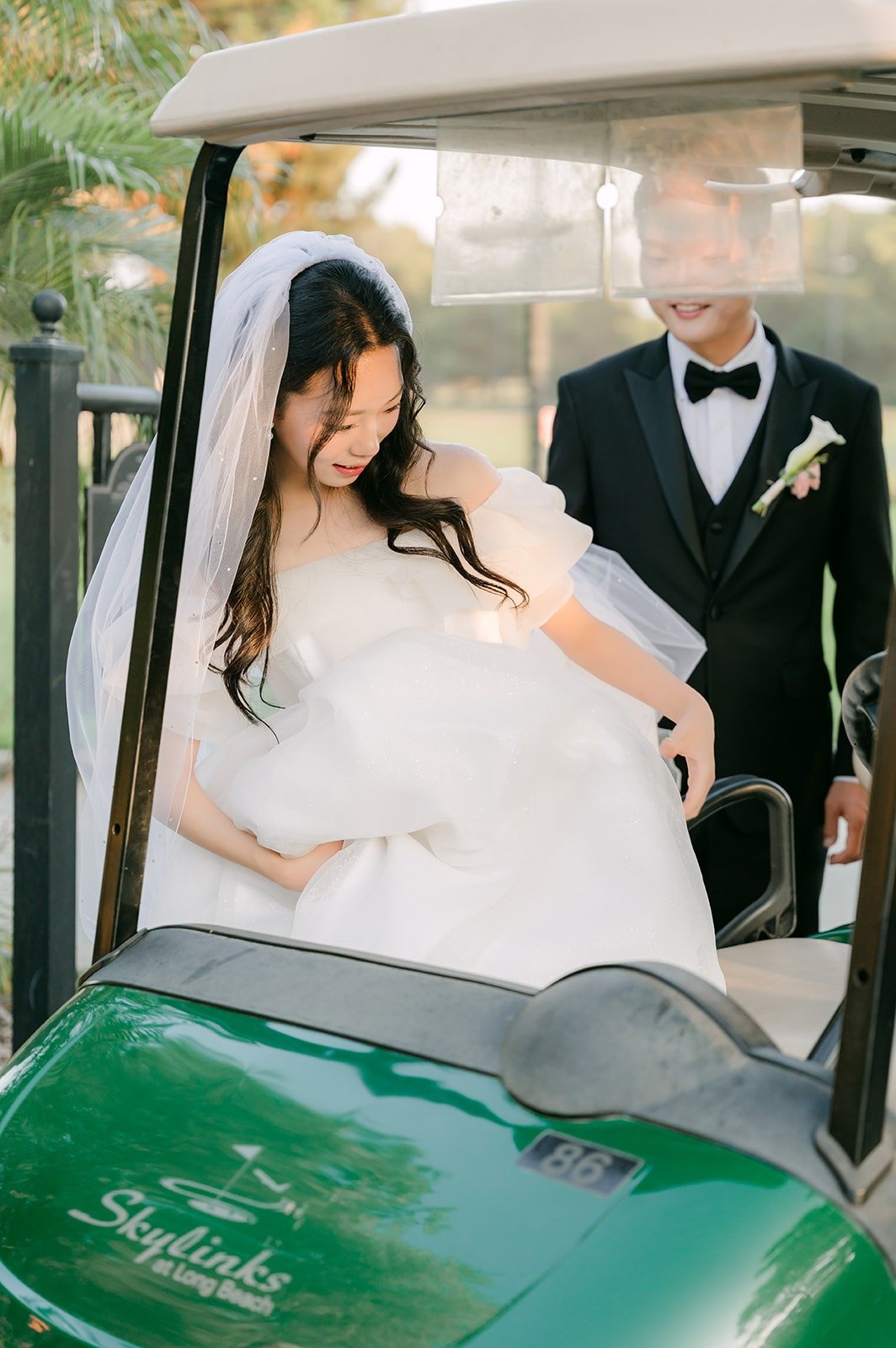 Jeannie and Eunsang heading out on a Skylinks golf cart