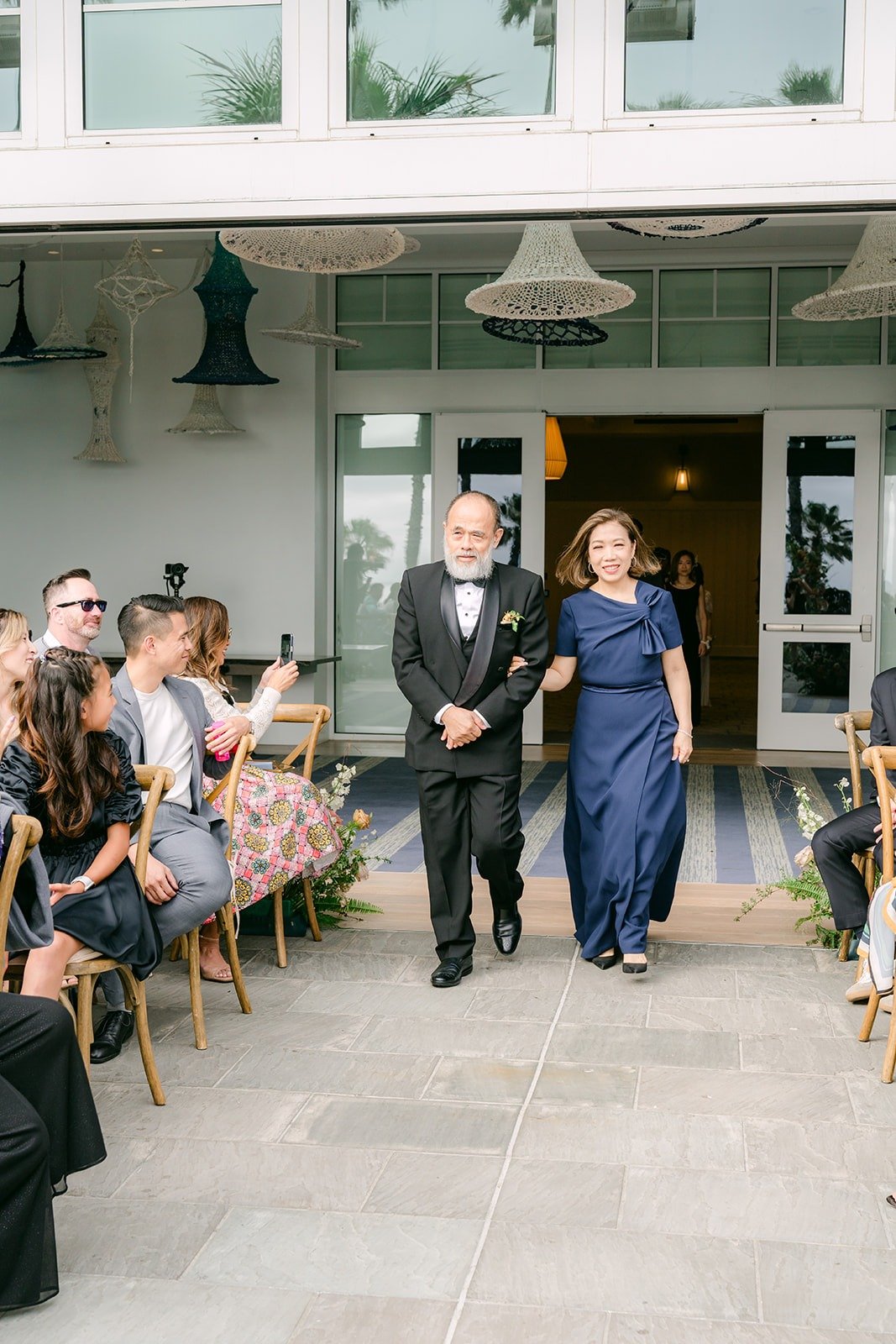 Two family members walking down the aisle during the processional