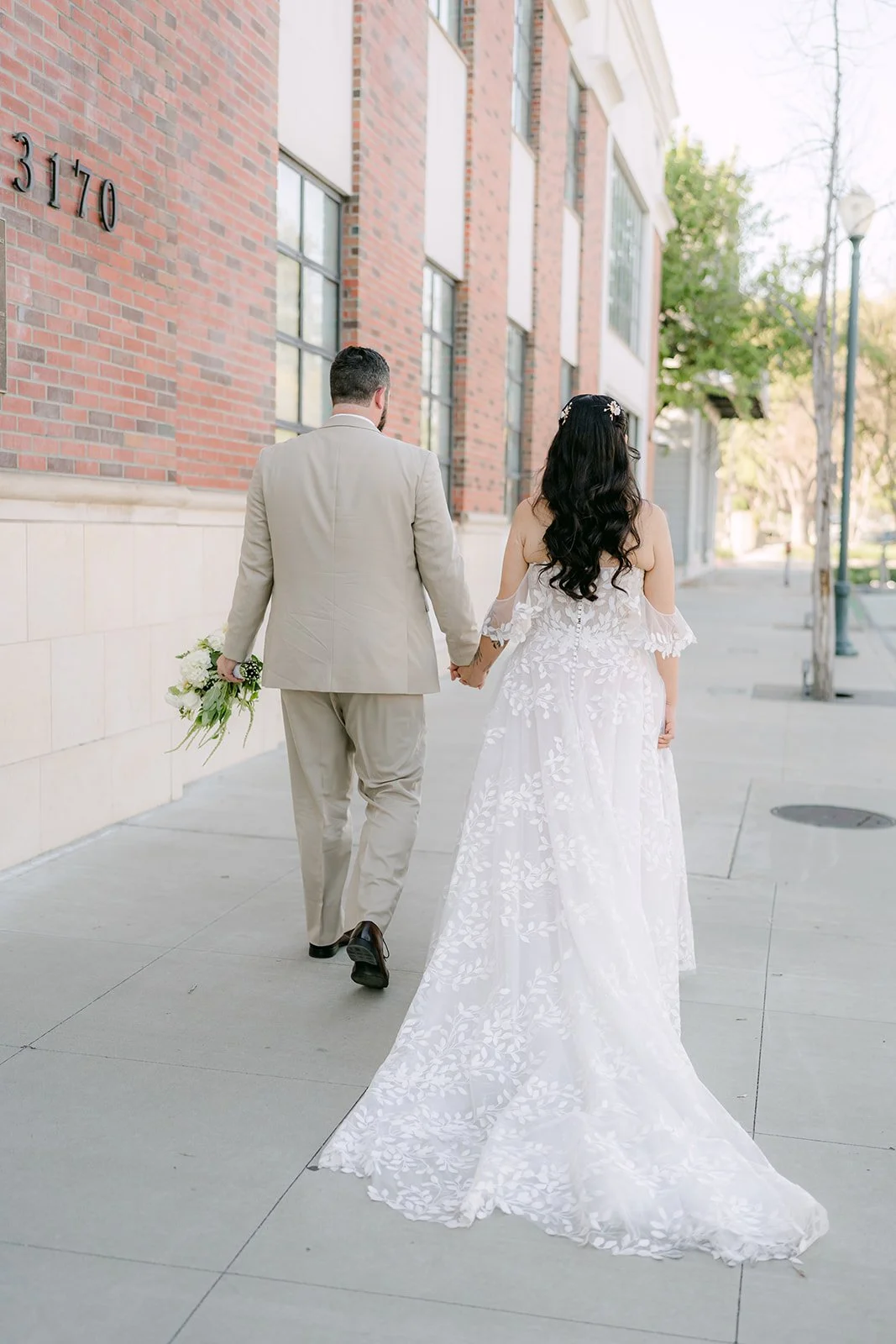 Fernanda and Cody walking down a brick-lined street.