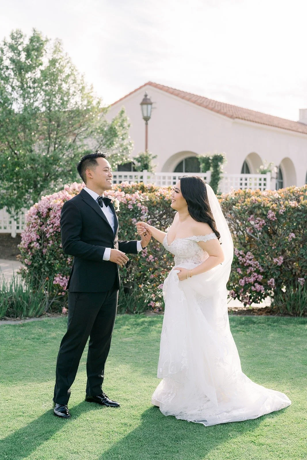 Francesca and Ralph walking hand in hand on the Clubhouse lawn