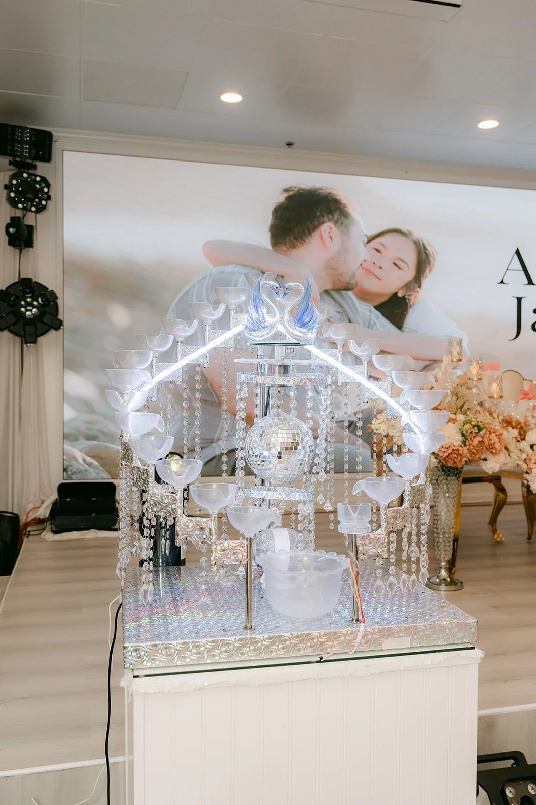 Amy and James opening a crystal champagne display filled with fog