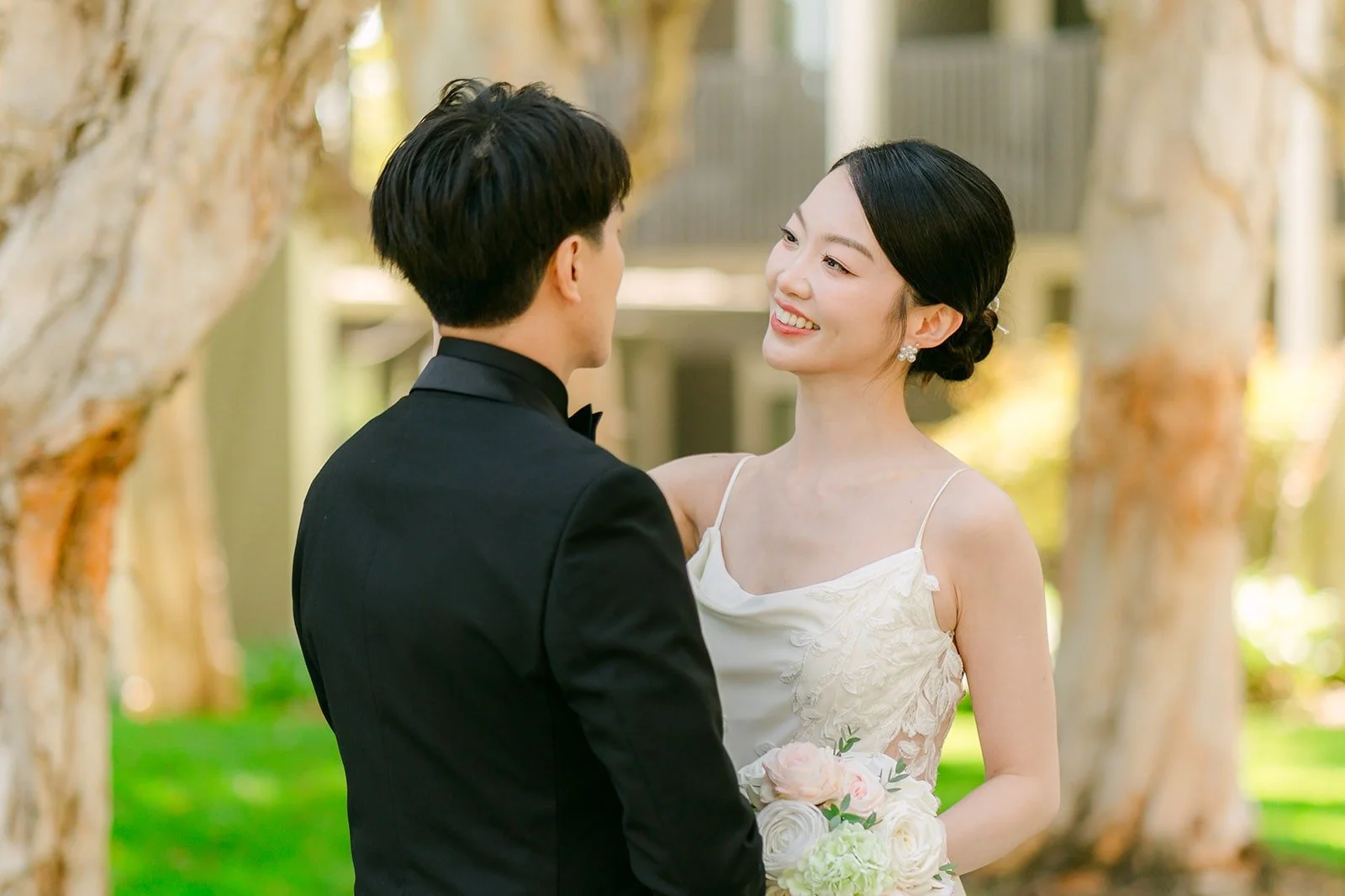 Tin and Fong smiling at each other under the trees, photographed by One and Only Production