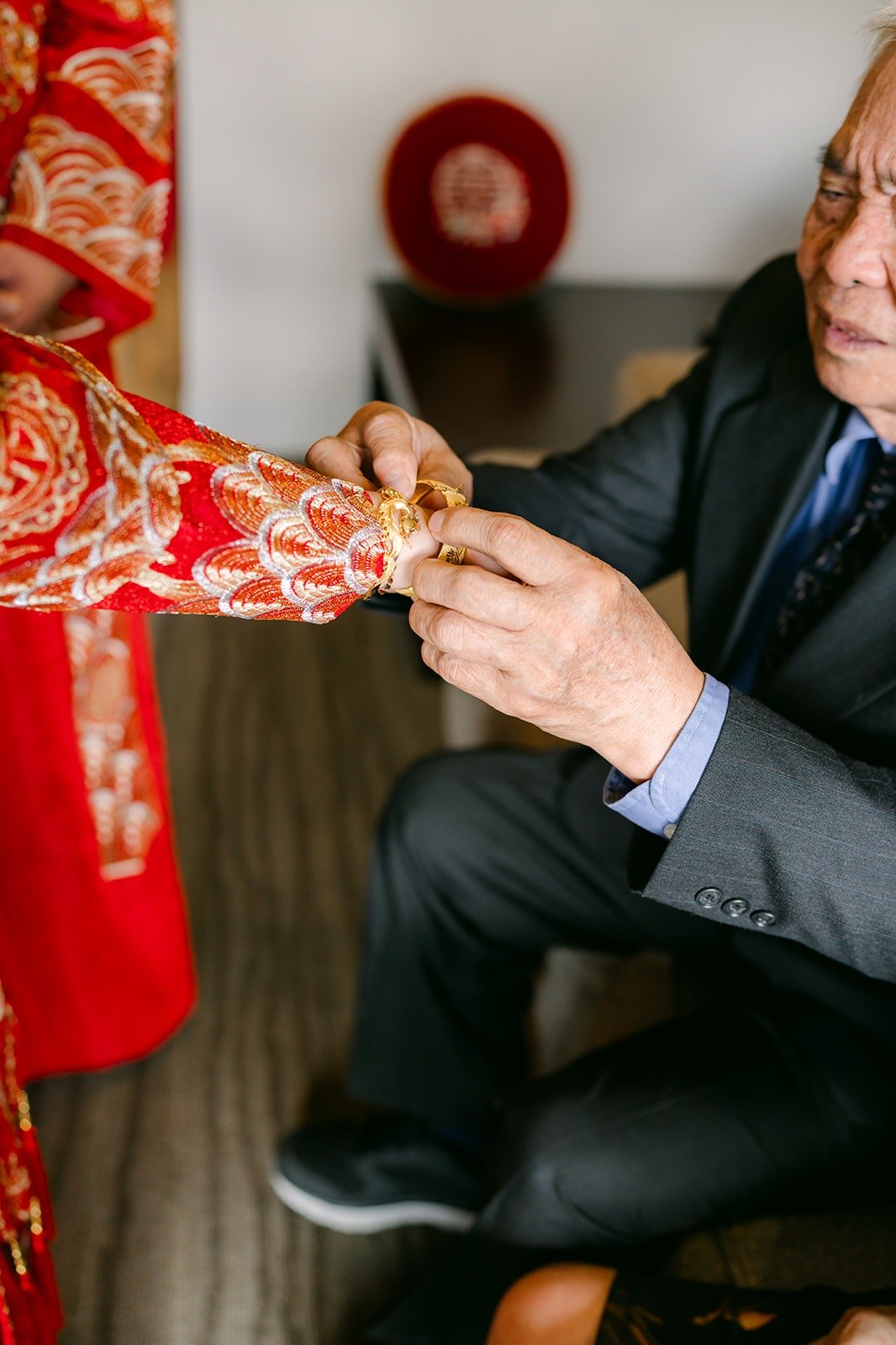 A family member receives tea from Sochi and Jay