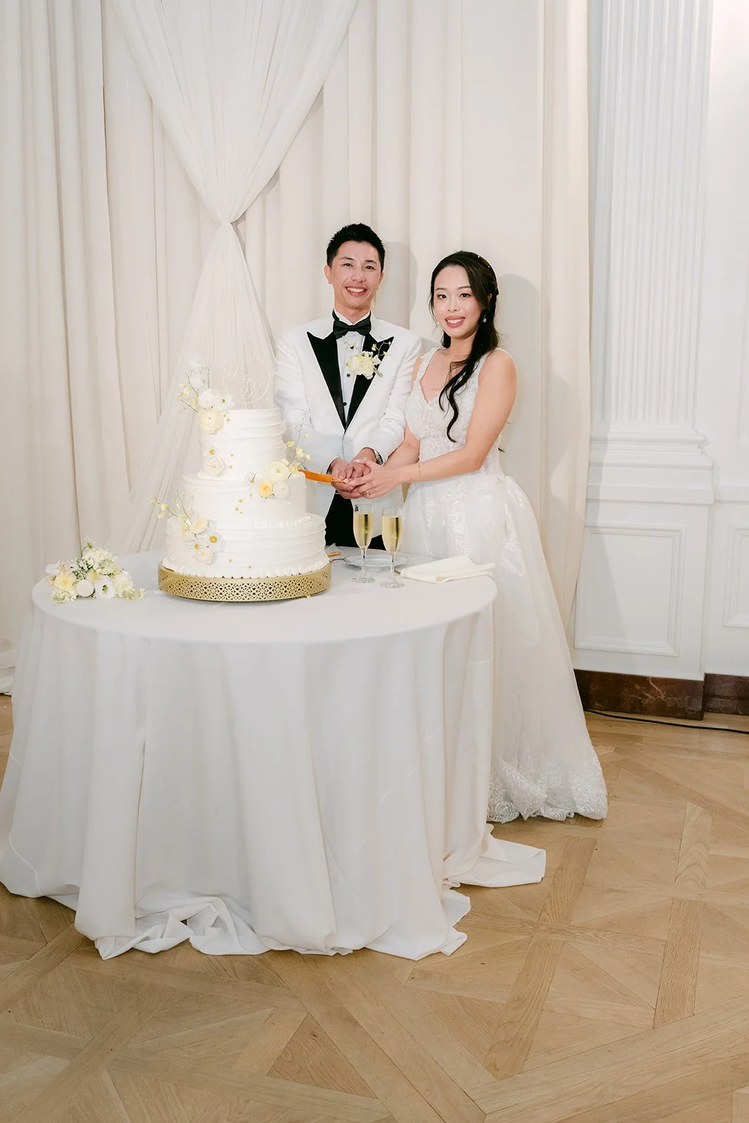 Jenny and Ryan behind their tiered cake.
