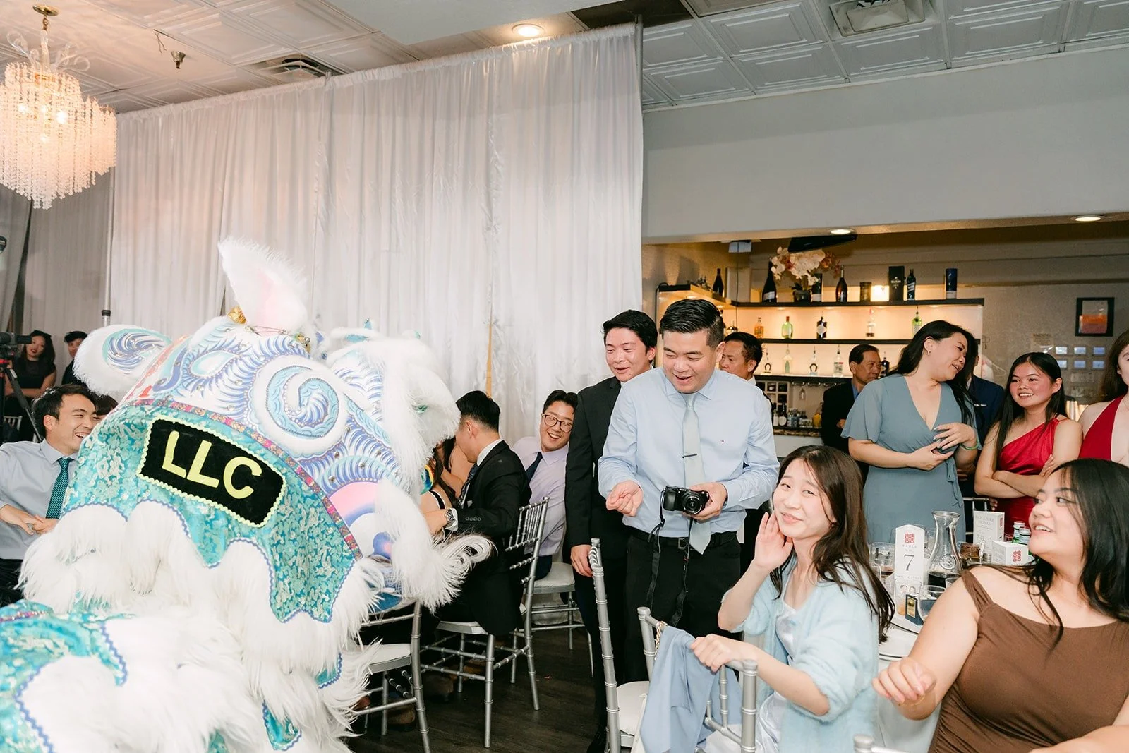 A blue and white lion dancing into the reception