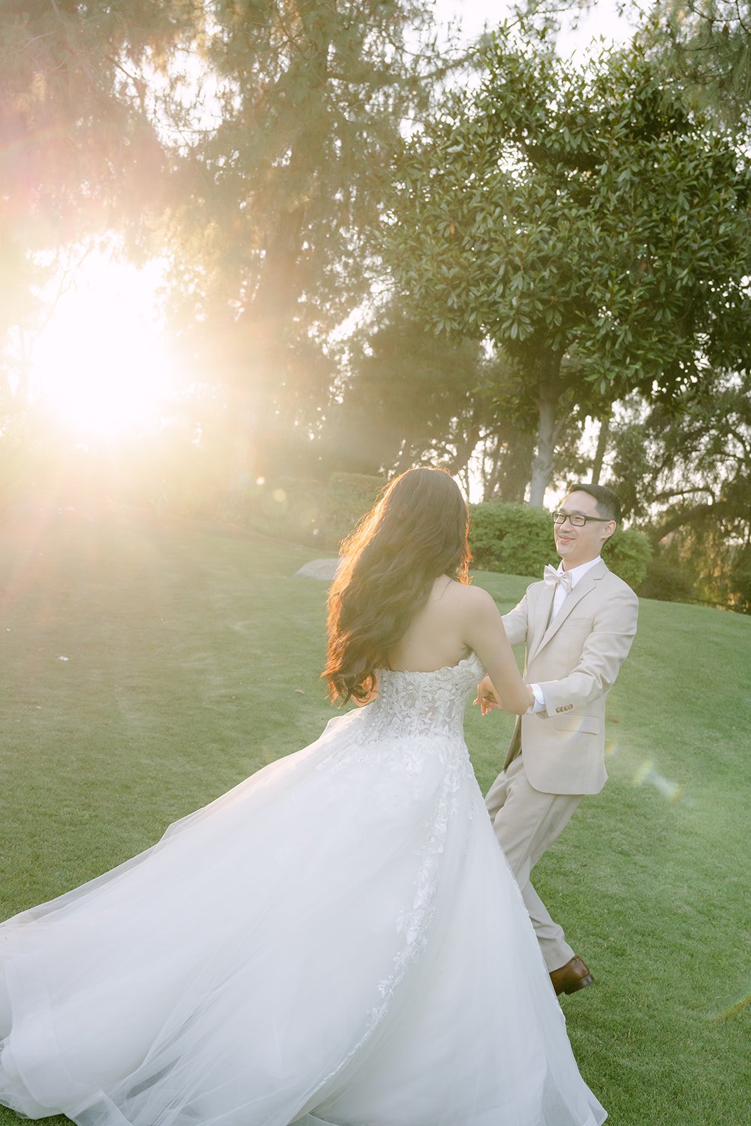 Sandra's ball gown glowing in the sunset as Kevin holds her hand.