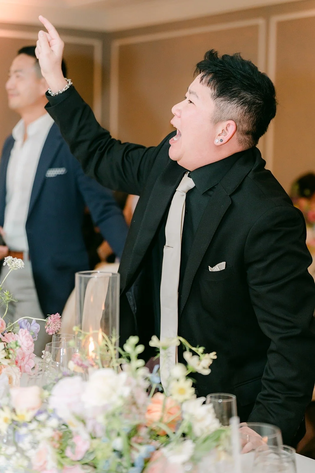A guest throwing his arm in the air during a reception game