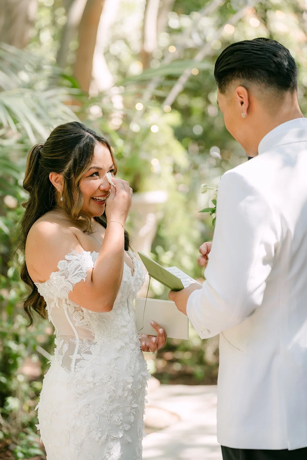 Nicole tearing up as Caryl reads his vows to her.
