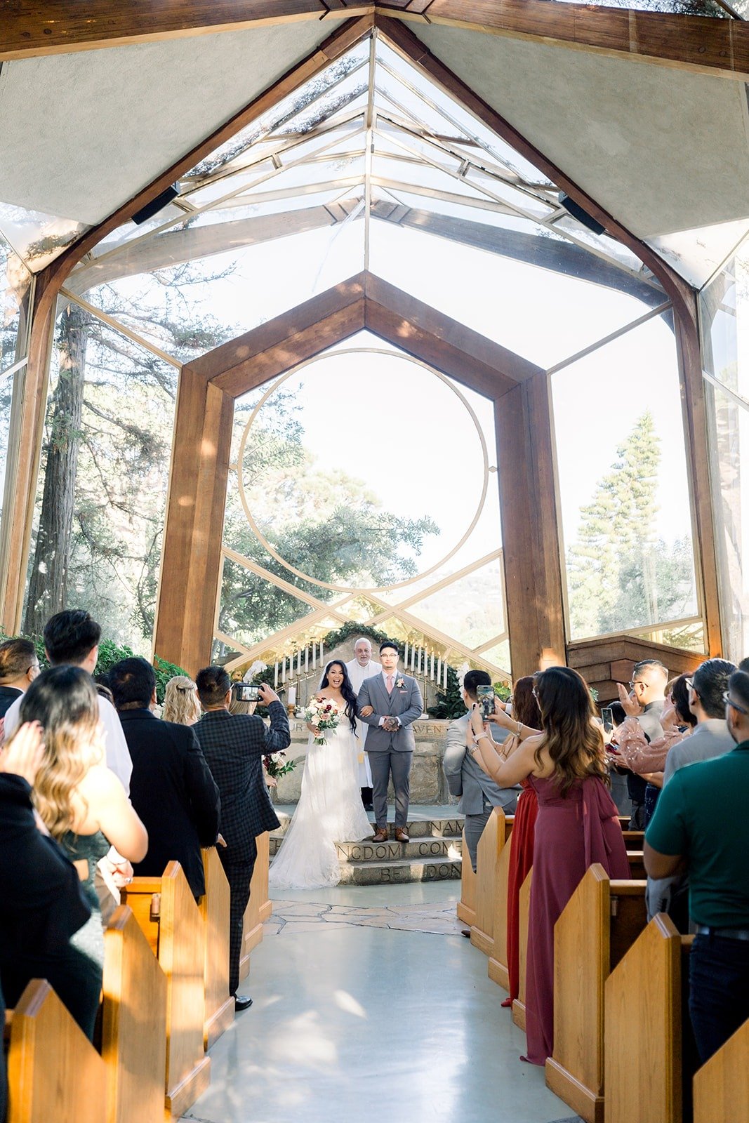 A wide view down the aisle of Wayfarers Chapel during the ceremony