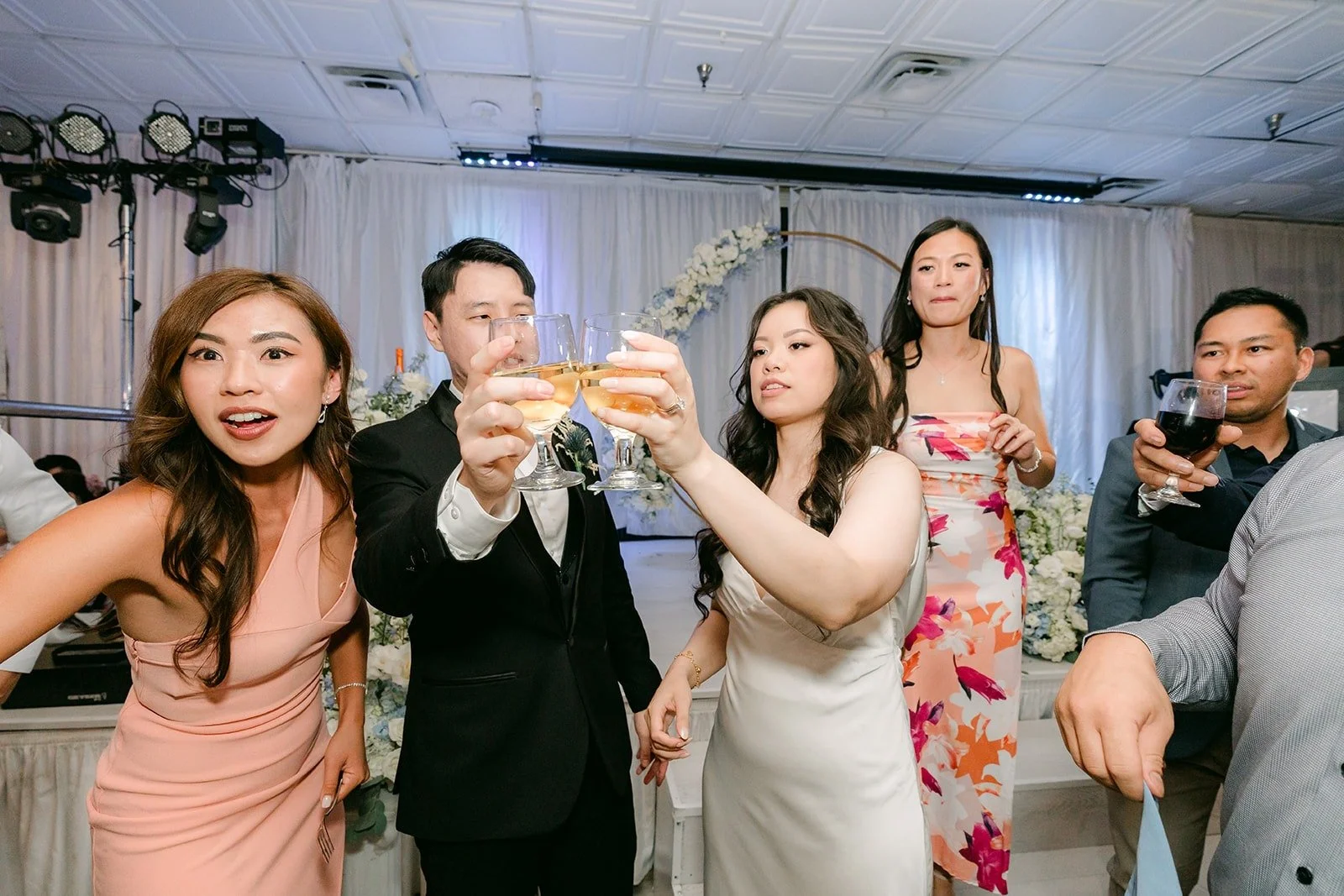 A table of friends cheering with Emily and James