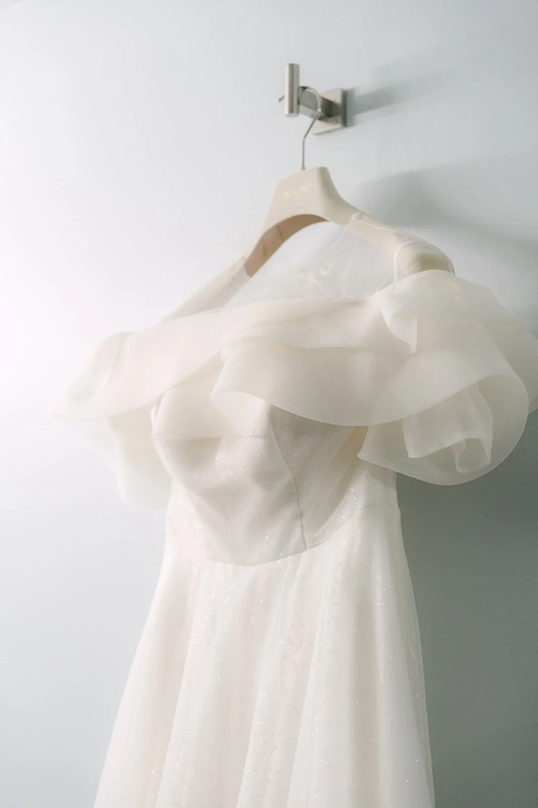 The puff sleeves of Jeannie's gown on the hanger