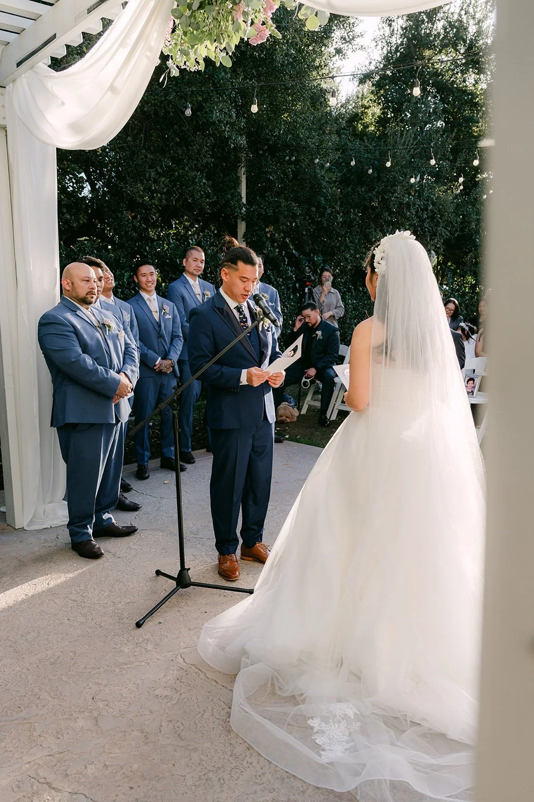 Kate and Michael facing each other under the white pergola.