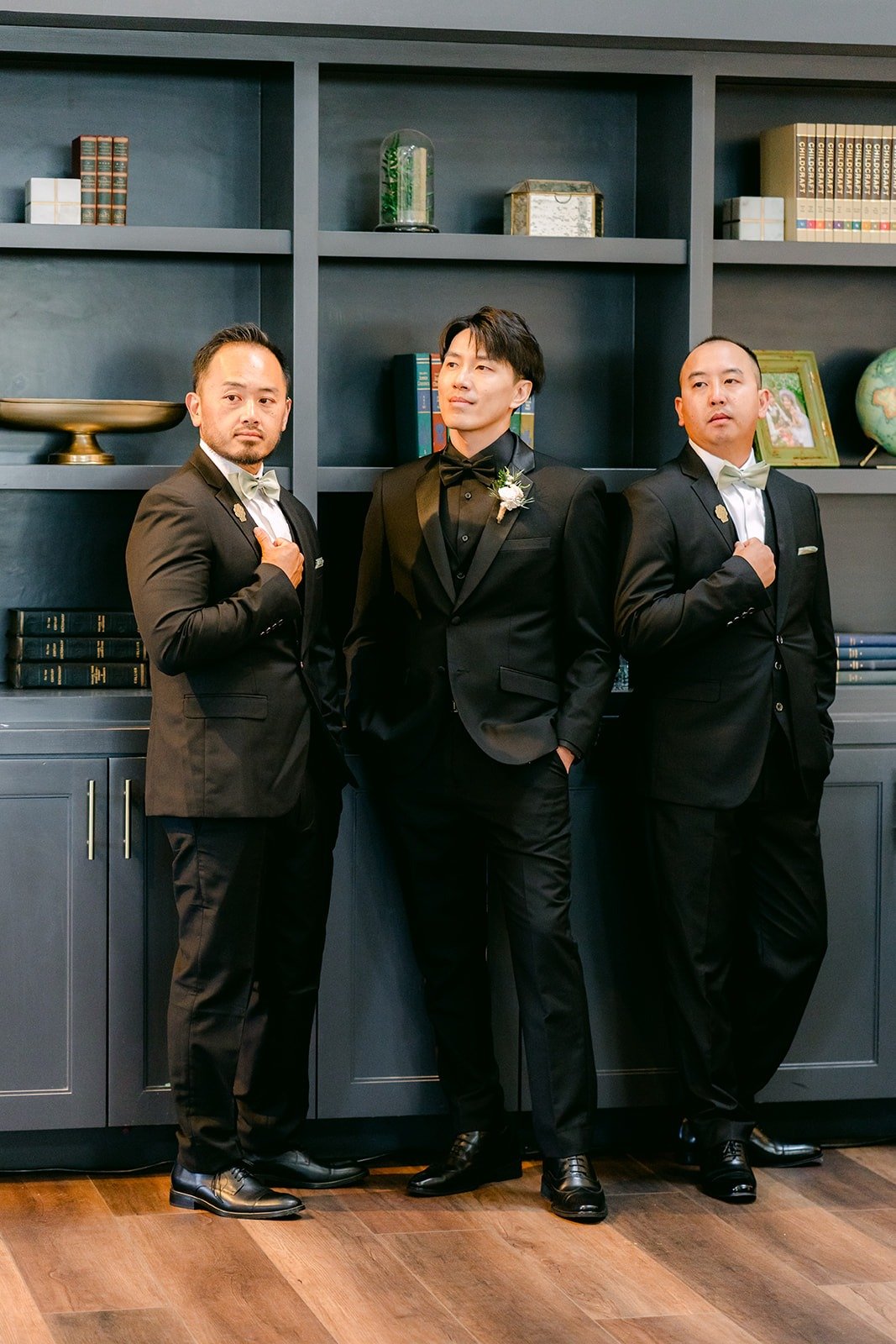 Fong and his groomsmen in black by the bookshelves