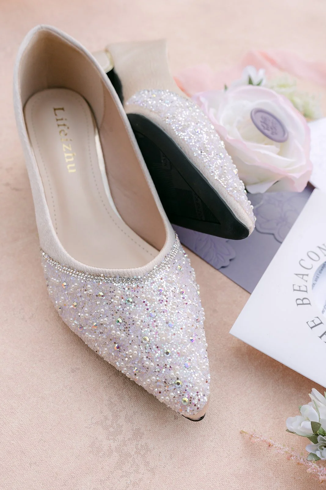 Kate's sparkling bridal heels beside the invitation suite.