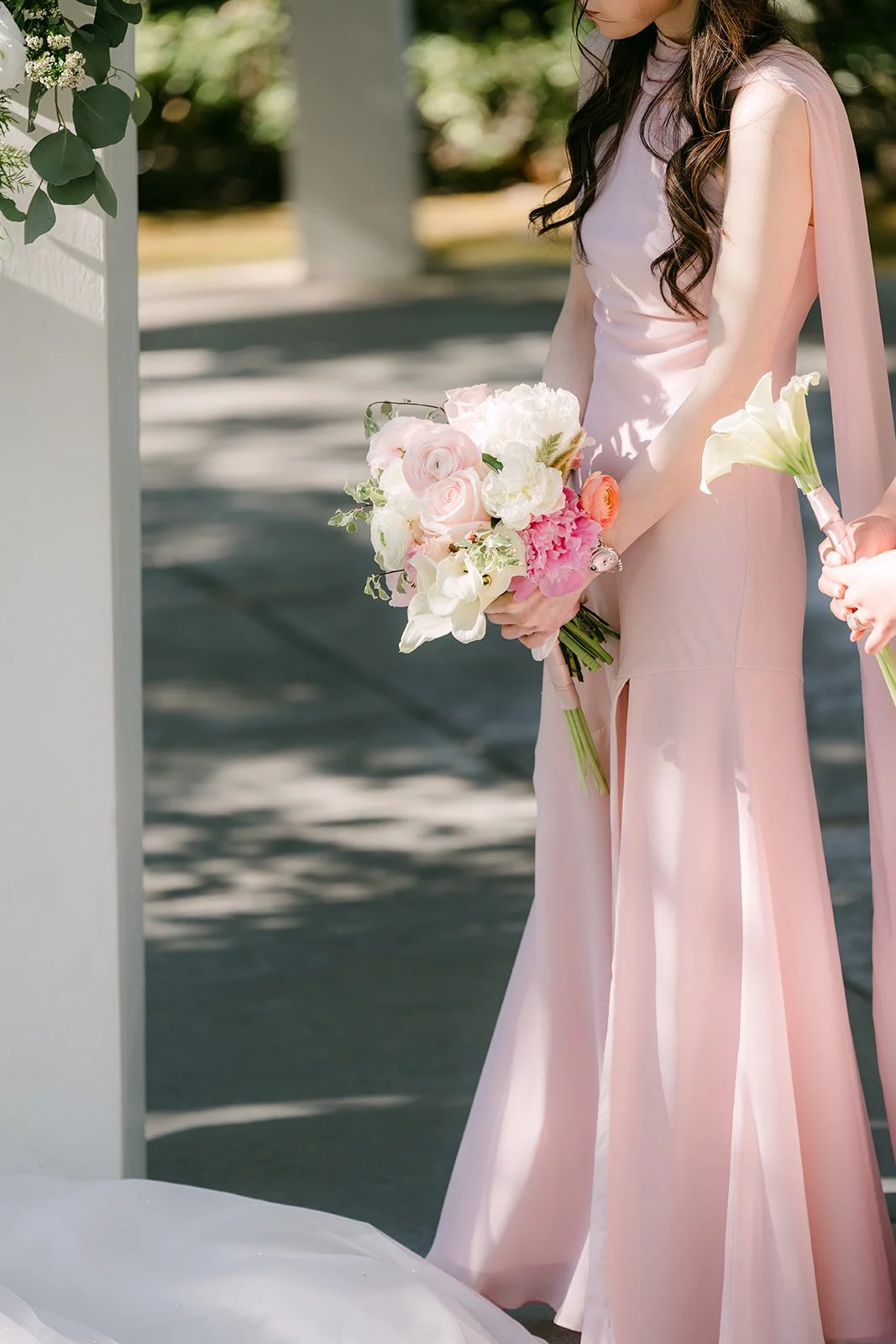 A bridesmaid holding her bouquet during the ceremony
