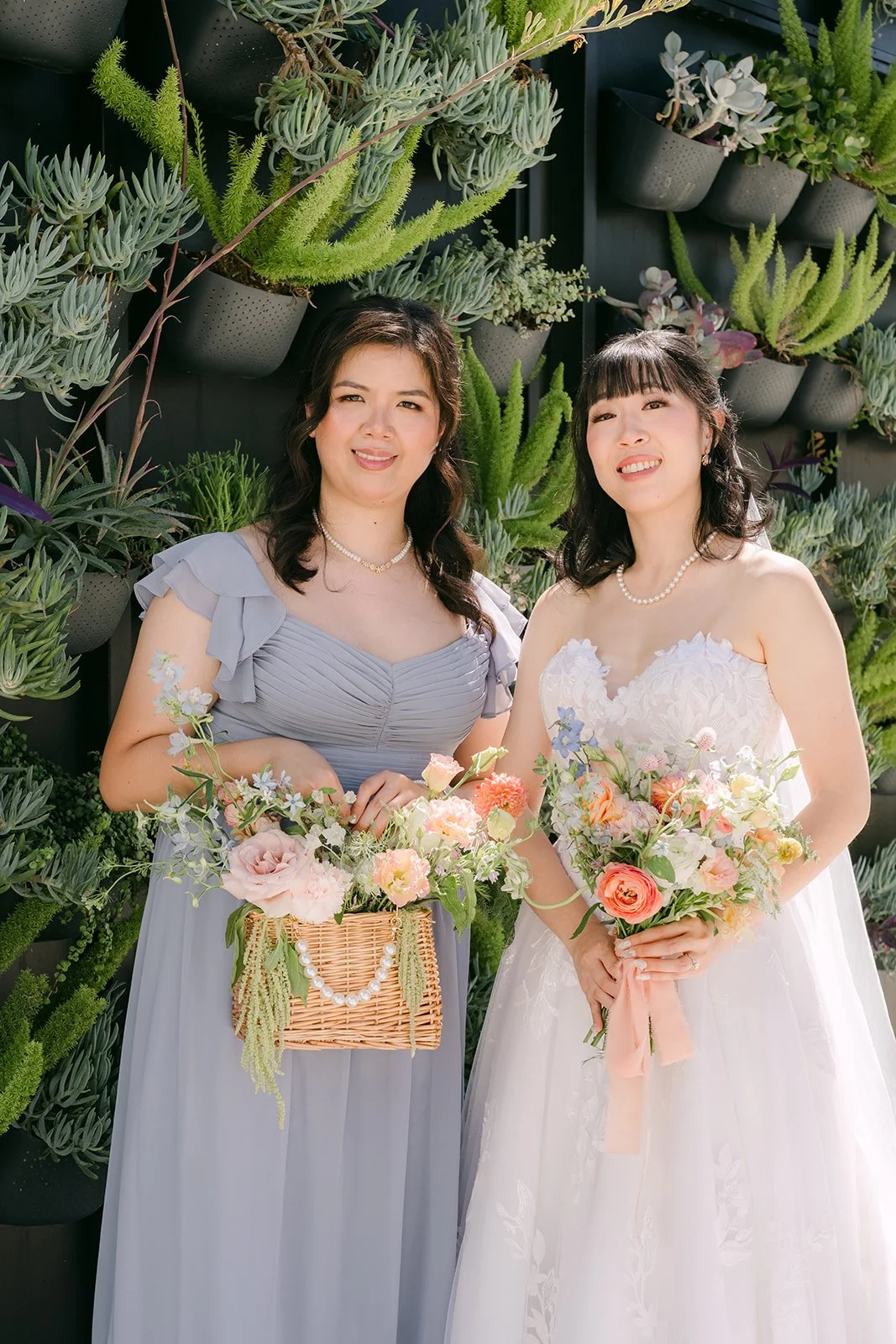 Vivian with a bridesmaid in front of the succulents