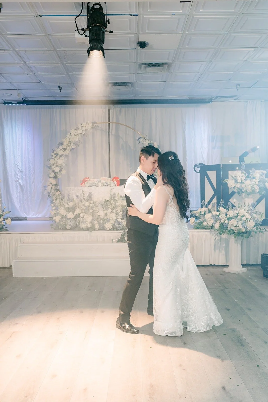 Emily and James finishing their first dance under the spotlight, photographed by One and Only Production