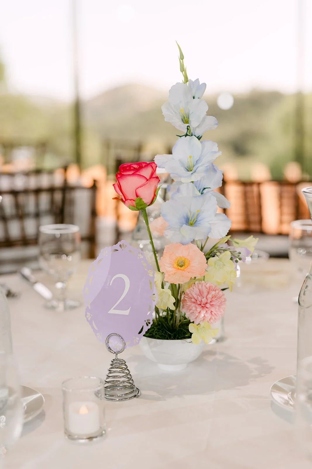 A pastel centerpiece with a lavender table number