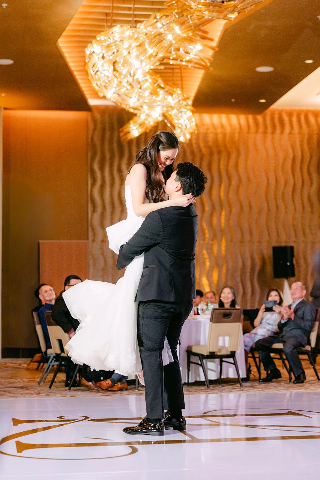 Groom lifting the bride on the dance floor