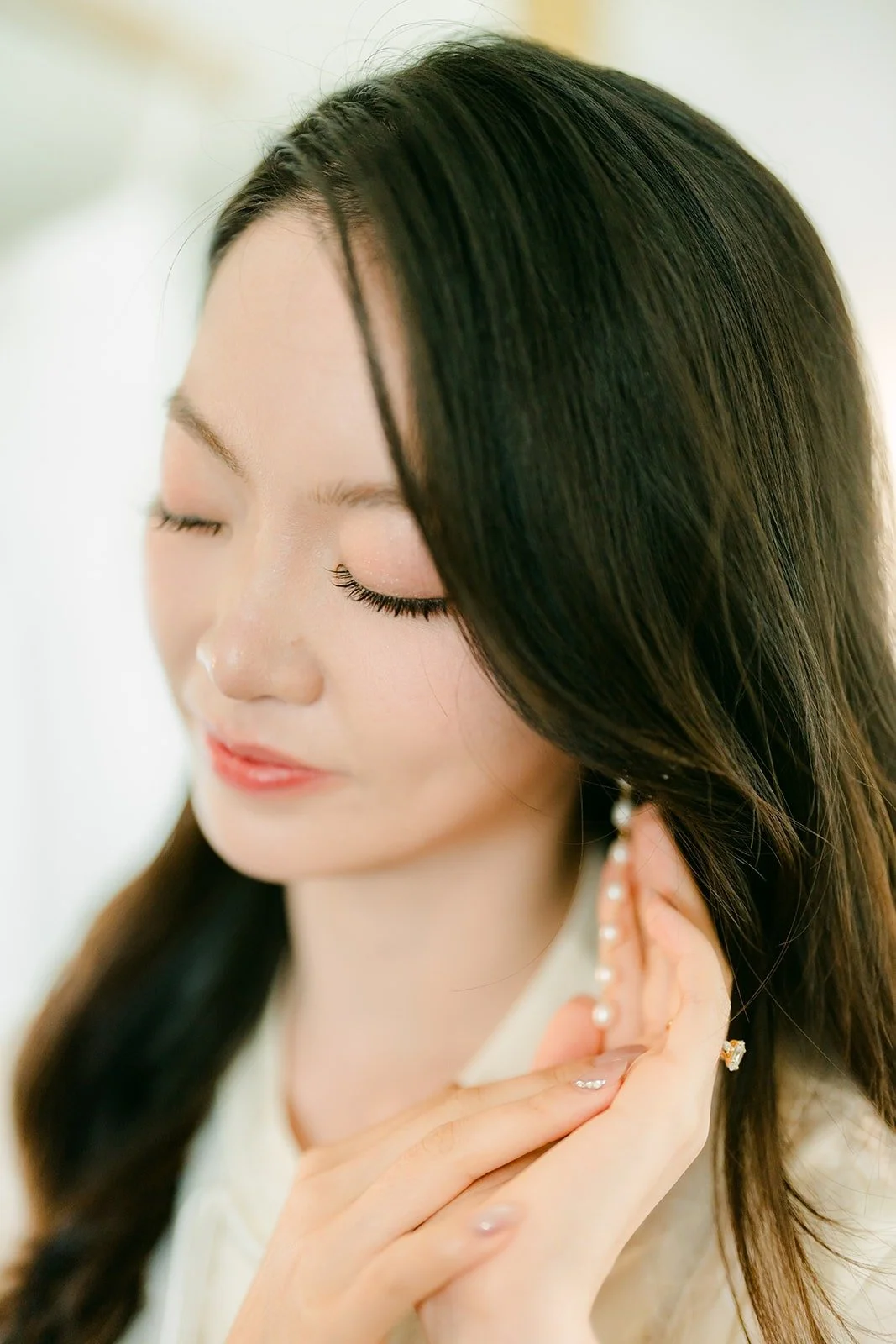 Close up of Tin touching her earring