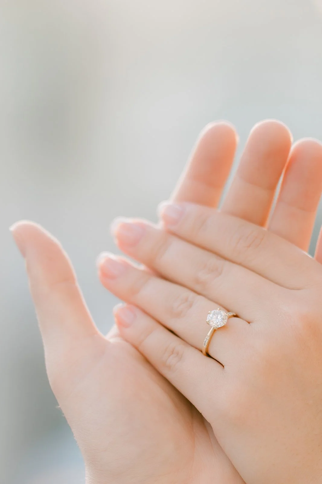 Close-up of Linh's engagement ring resting on Ankush's hand.