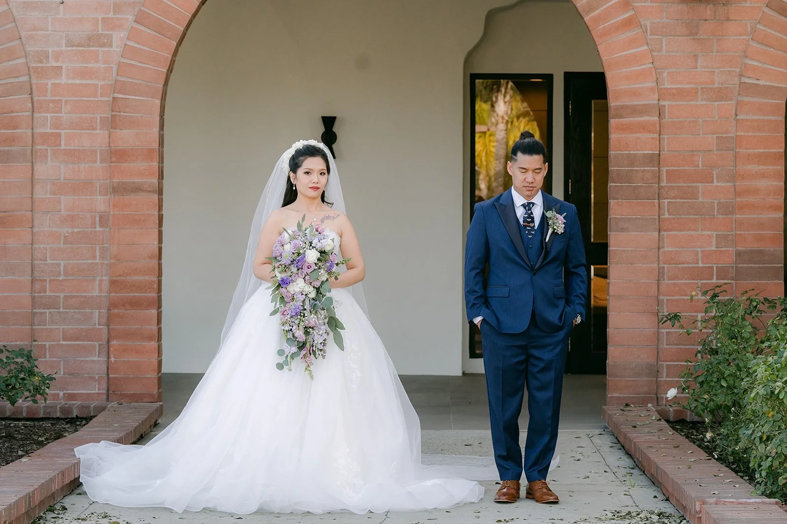 Kate and Michael in front of the brick arches at Sierra La Verne before their first look.