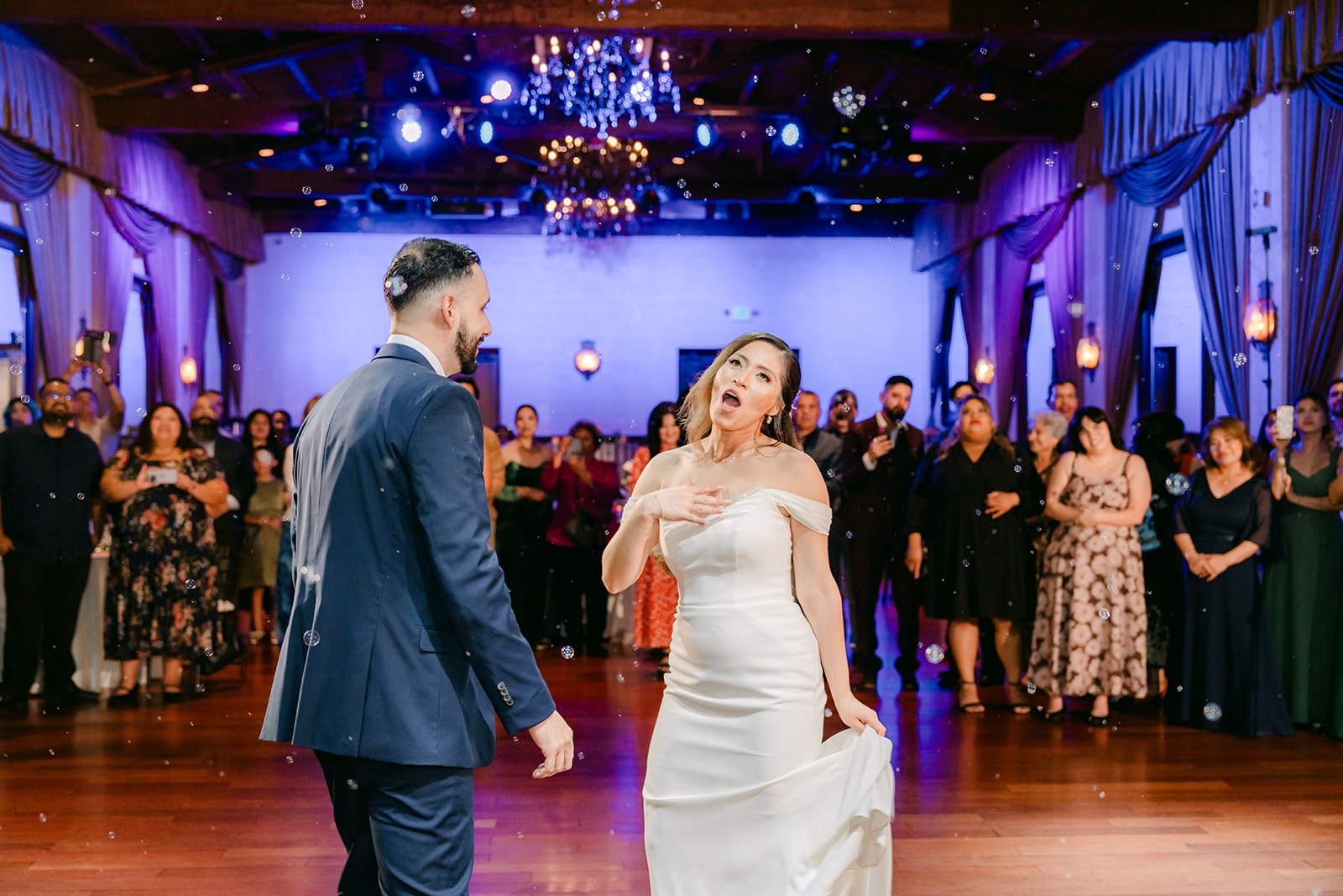Mariana laughing with Danny on the dance floor, photographed by One and Only Production