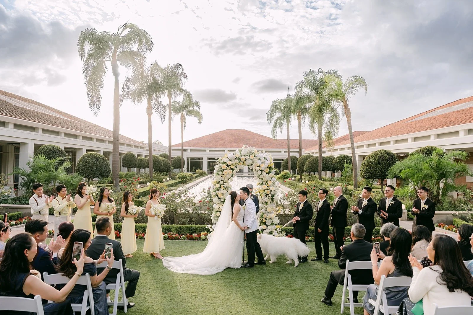 Wide view of the ceremony on the lawn at the Nixon Library with palm trees.