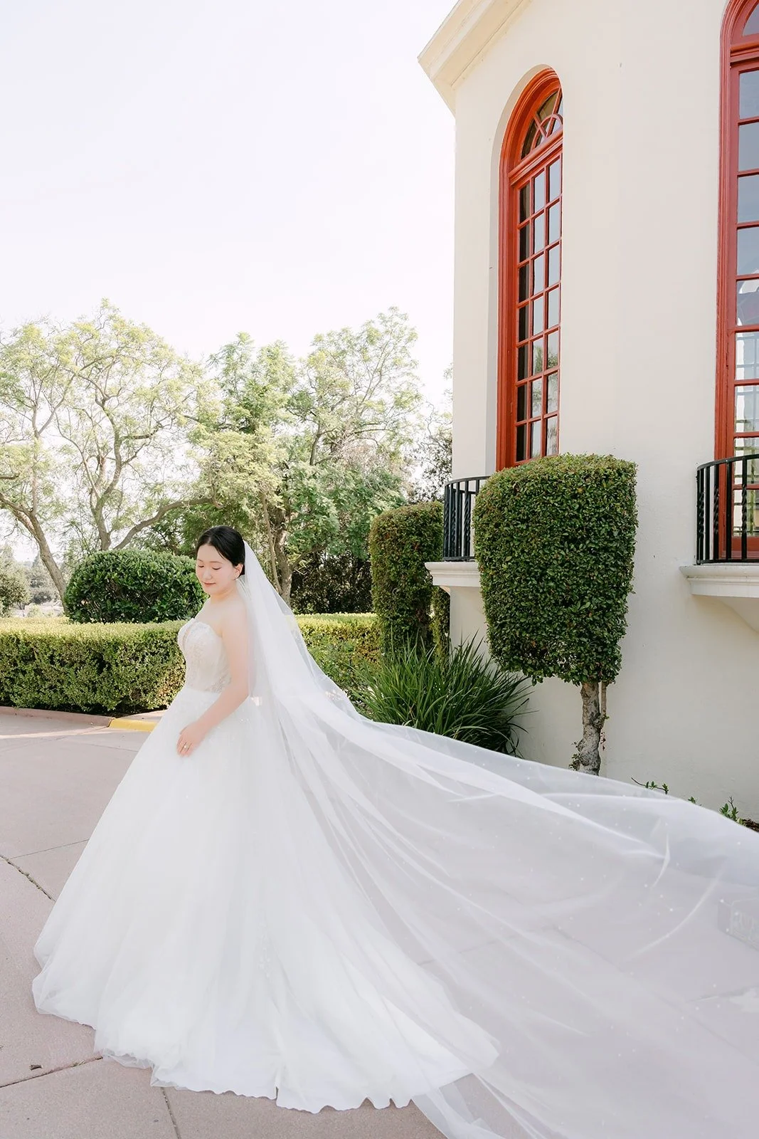 Amy in her gown beside the arched windows
