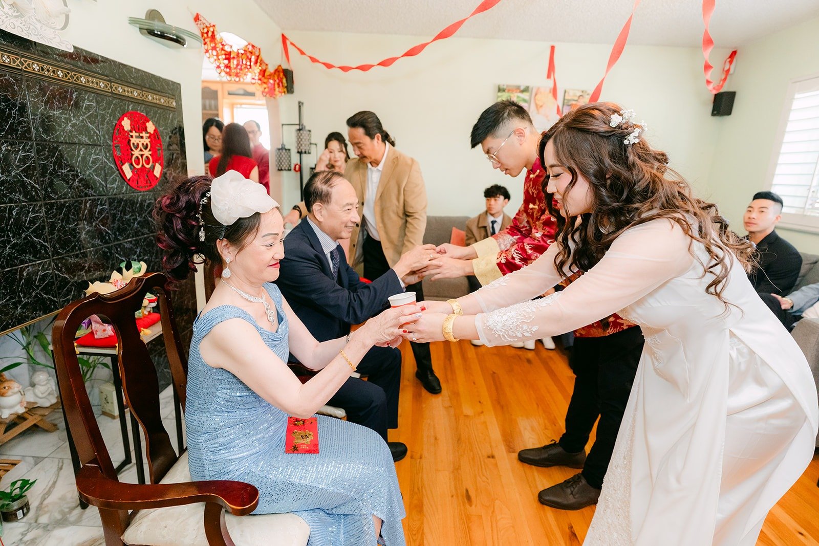 Shayna and Robert offer tea to family during the tea ceremony in Alhambra