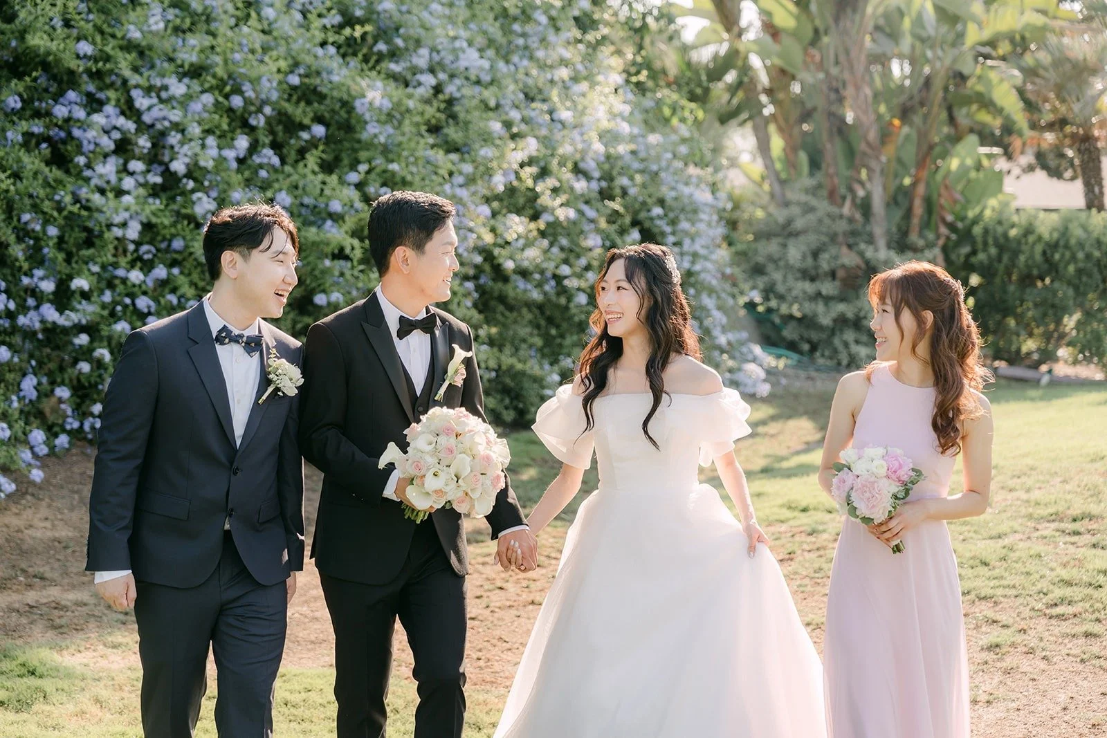 The couple and their maid of honor and best man on the lawn at Skylinks Golf Course