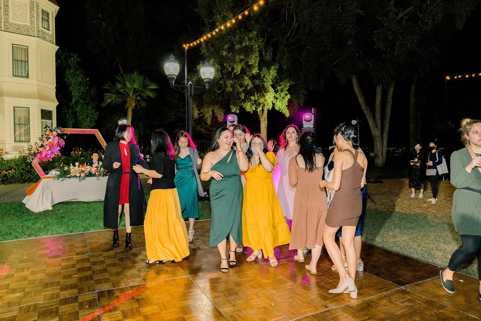 Guests gathering on the dance floor for the bouquet toss