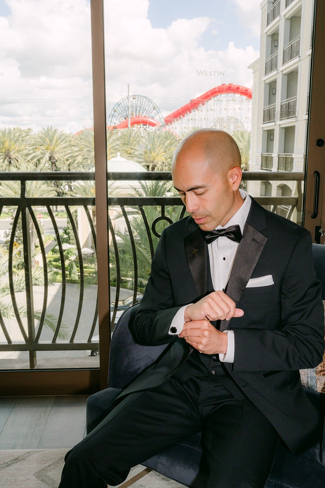 Daniel fastens his watch in the Groom Suite