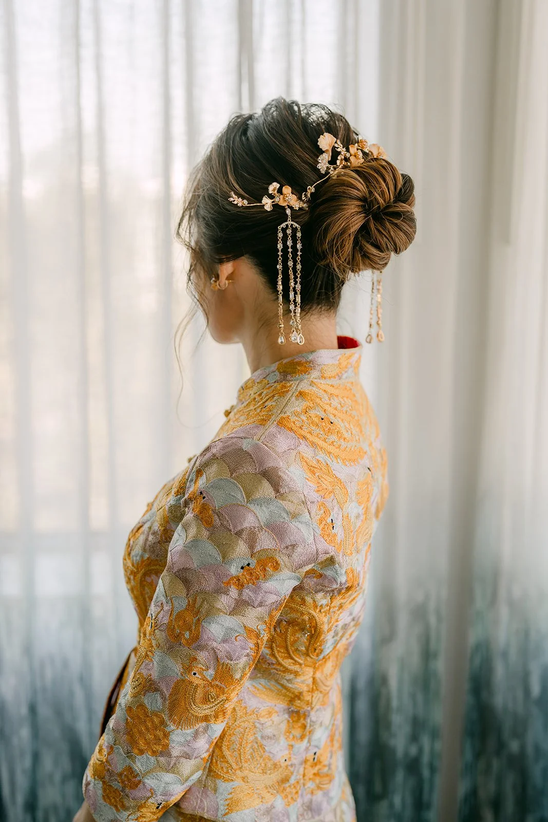 Christie's hairpiece and updo seen from behind as she looks out the window.