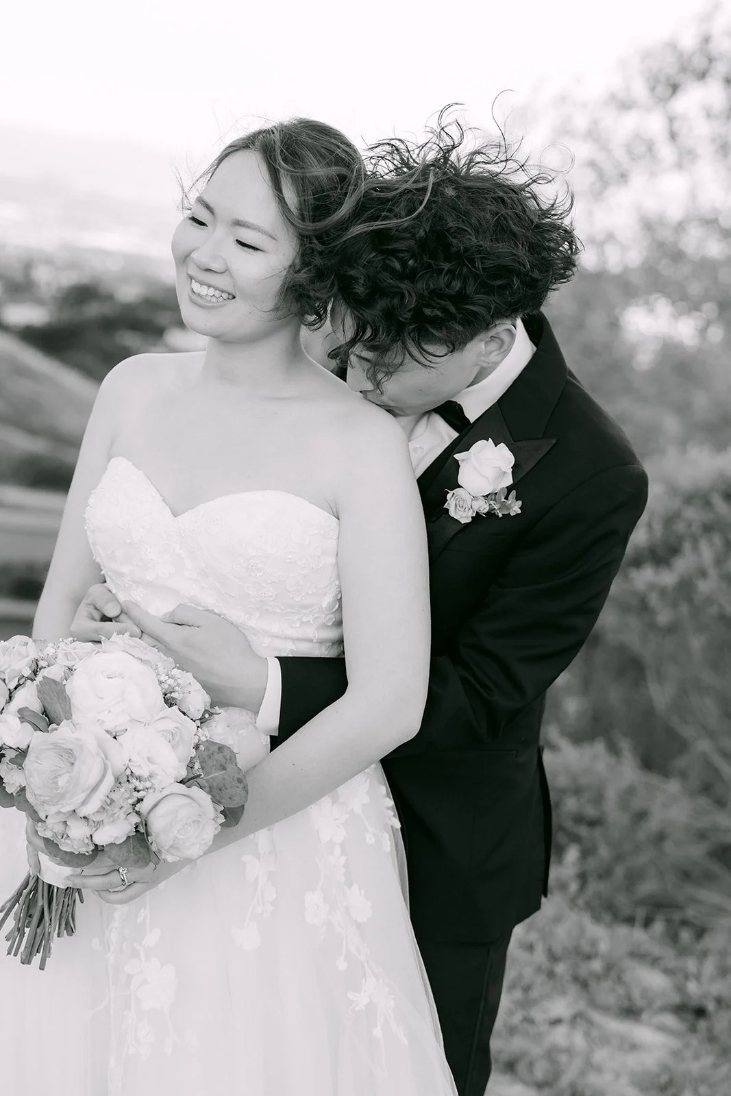 Black and white of Tony hugging Victoria from behind