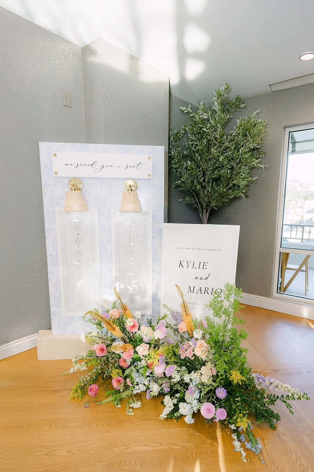 A floral display and clear acrylic sign at the entrance to the reception at Surf & Sand Resort