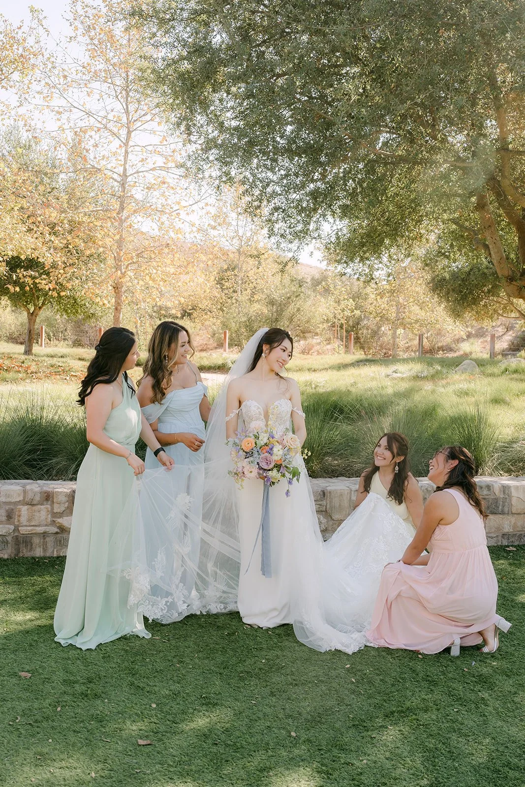 Christie and her bridesmaids gathered on the lawn at Quail Hill Community Center, photographed by One and Only Production.