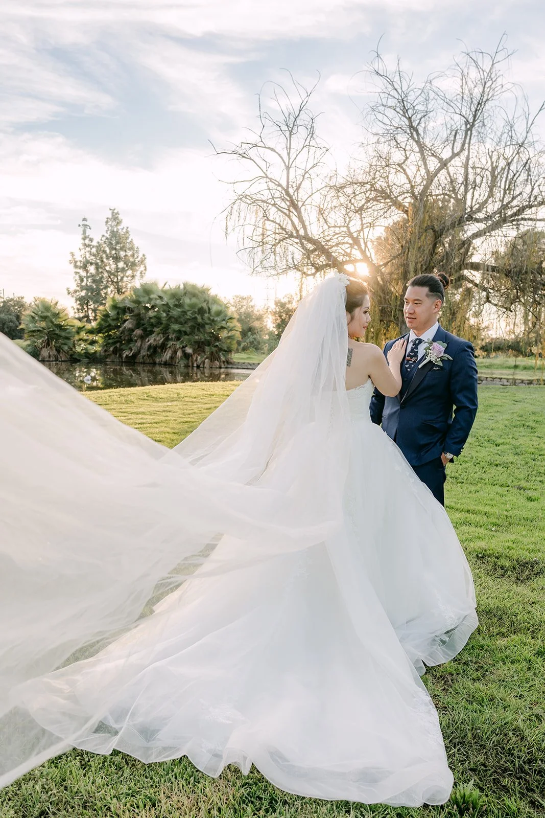 Michael holding Kate's veil as it lifts in the breeze.