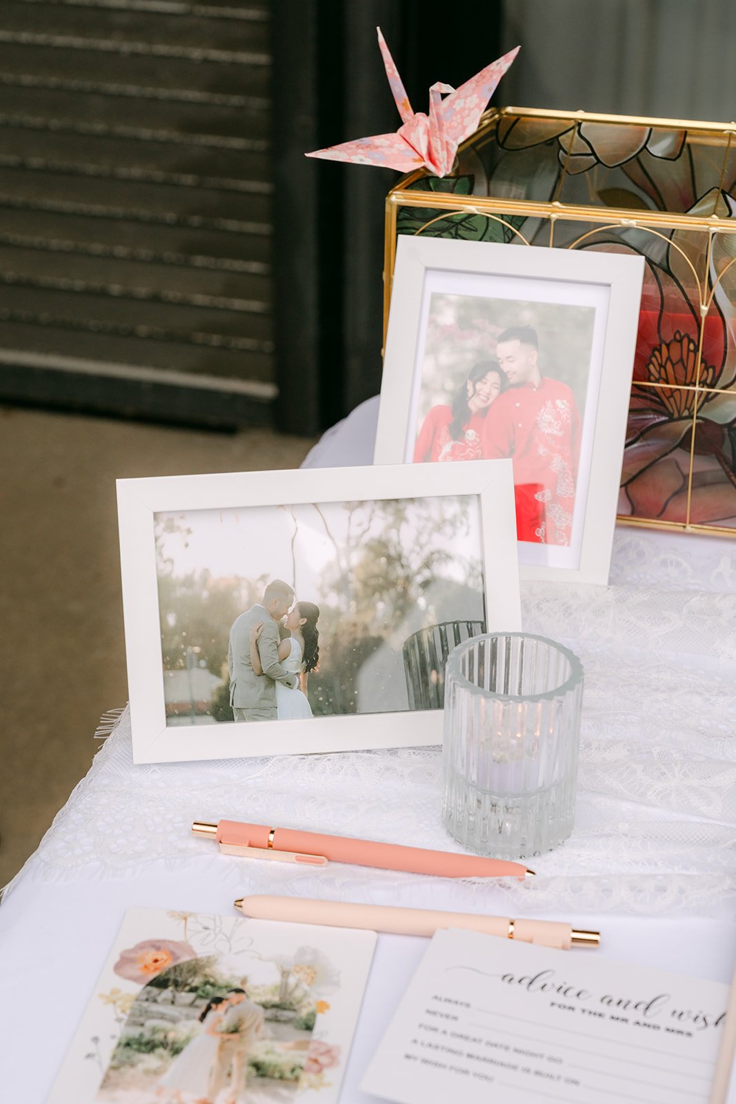 Paper cranes and framed photos on the welcome table