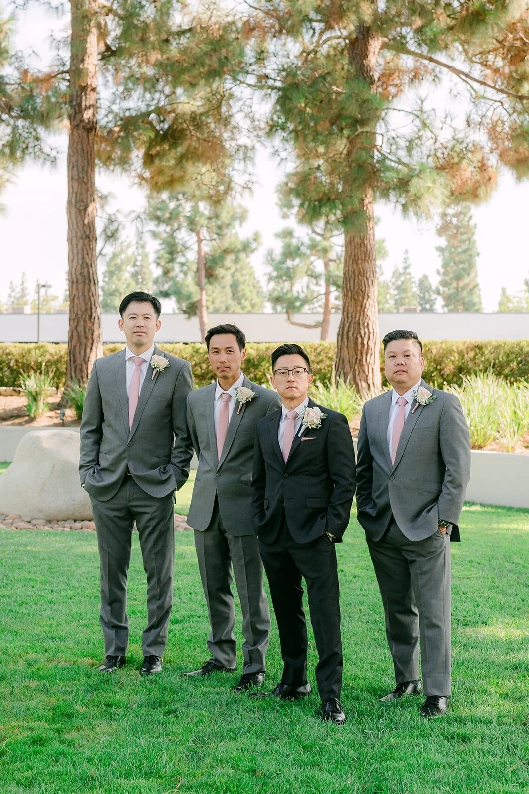 Alex and his groomsmen lined up on the lawn, photographed by One and Only Production