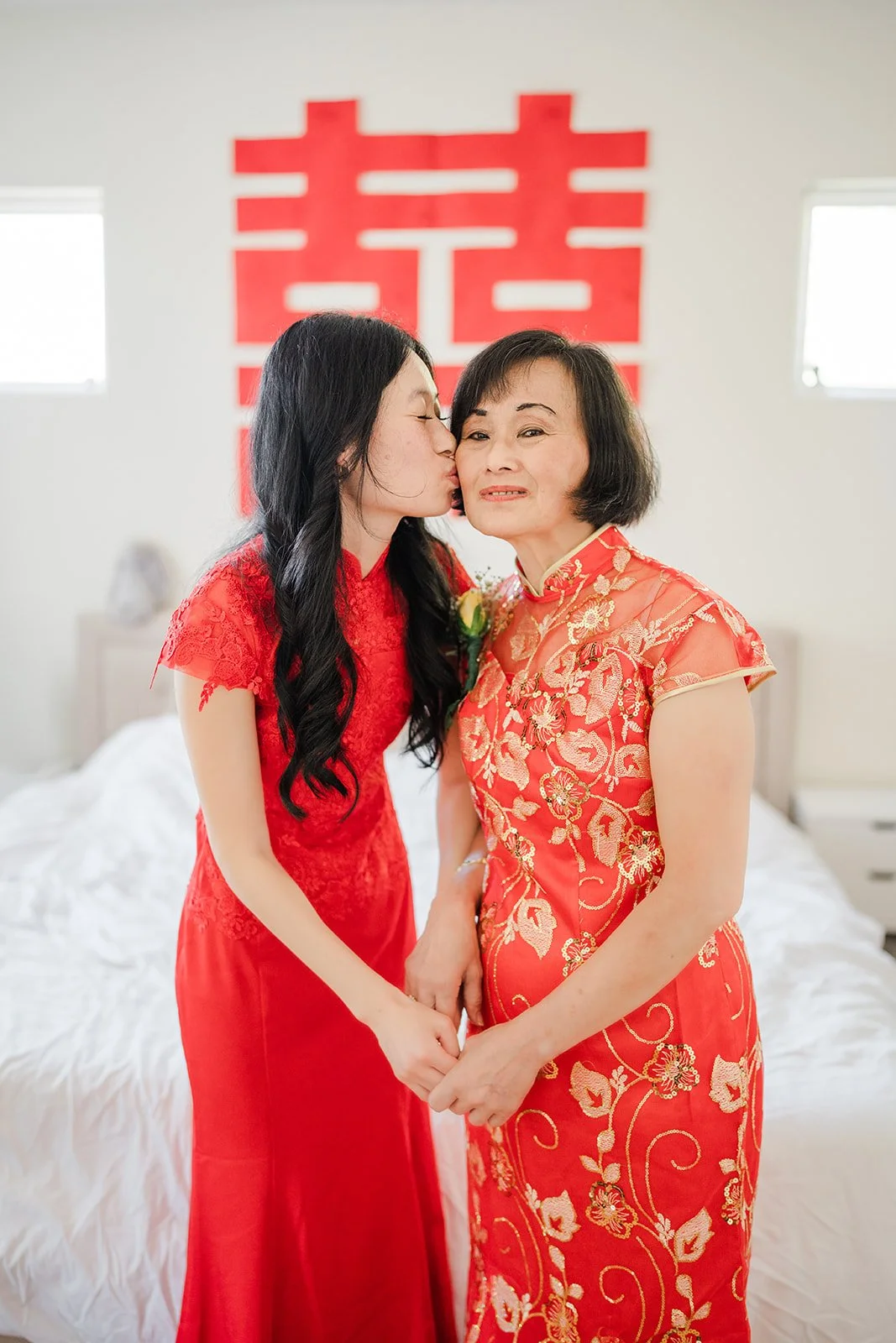 Valerie with her mother under a double happiness sign.