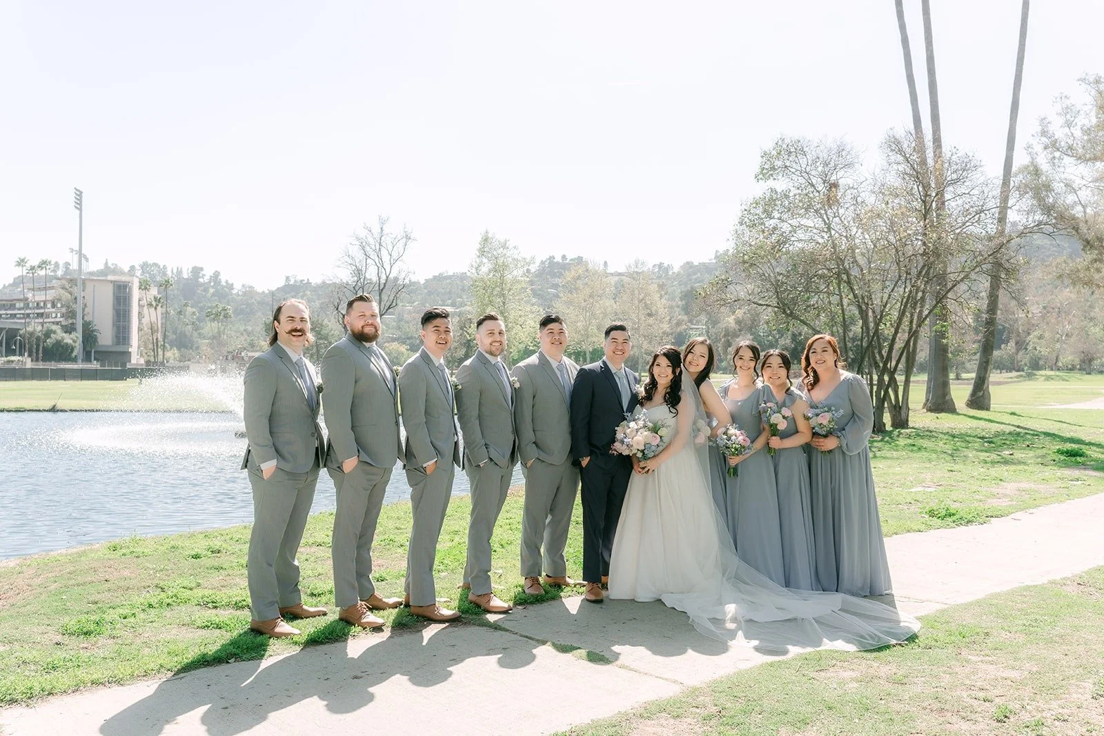 Florence, Jordan and the wedding party lined up along the pond