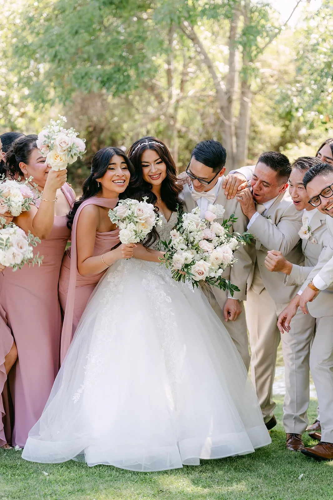 Sandra surrounded by her bridesmaids and groomsmen, photographed by One and Only Production.