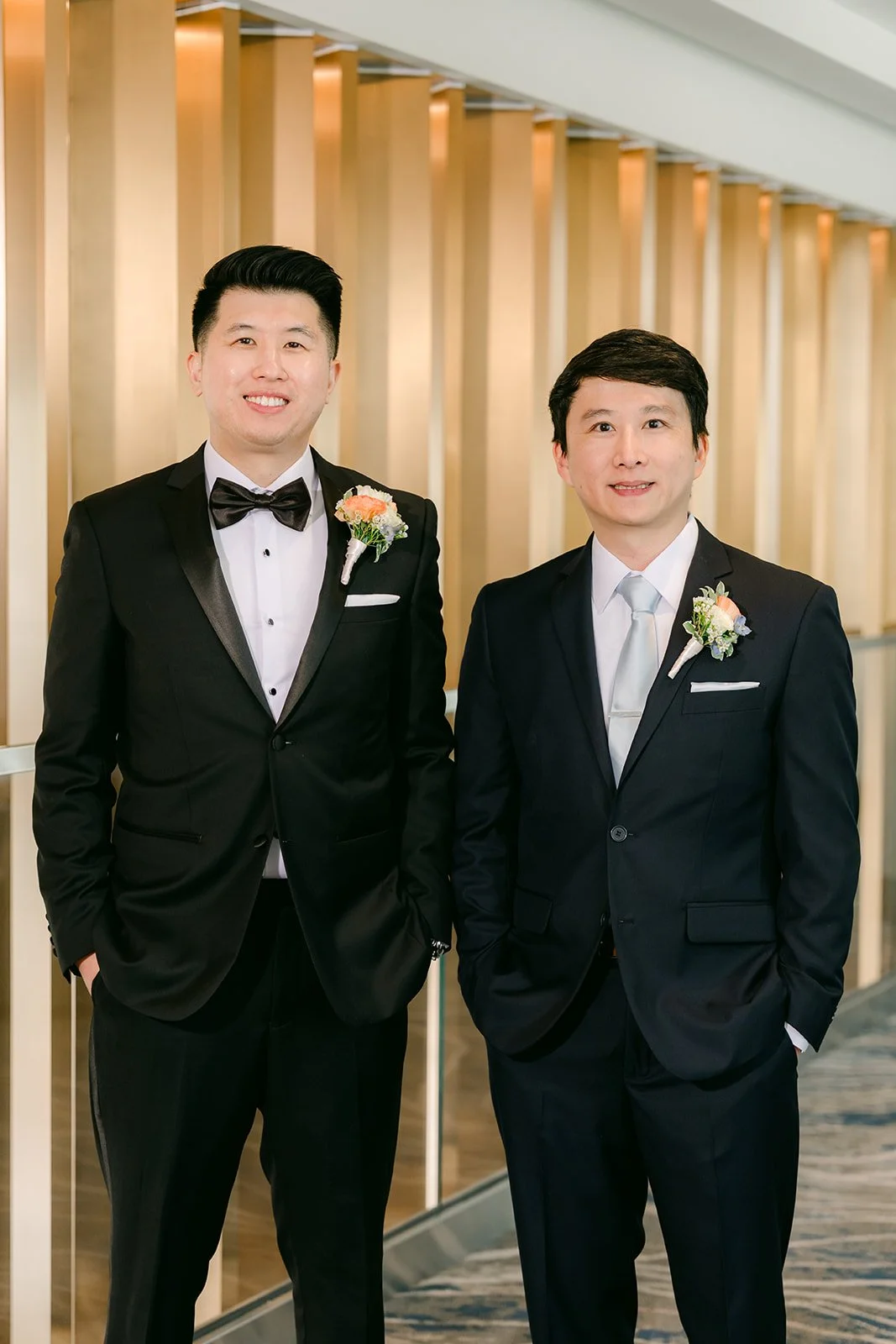 San with a groomsman in a white boutonniere.