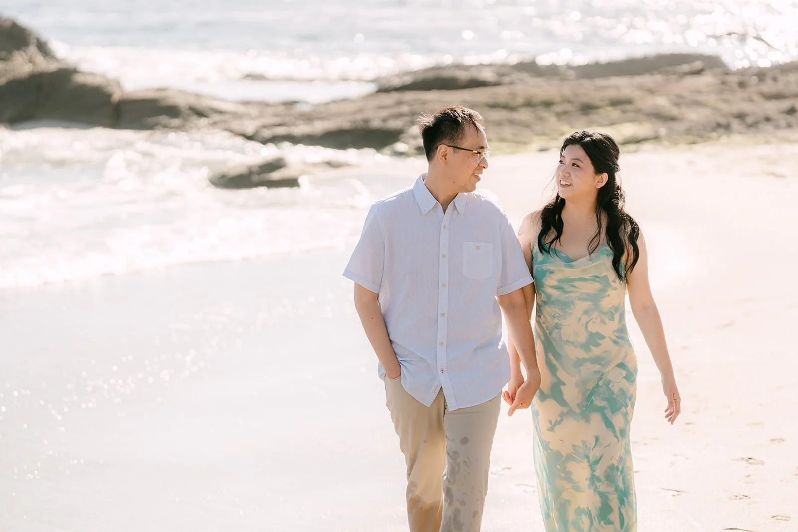 Constance and Lawrence walking along the beach.