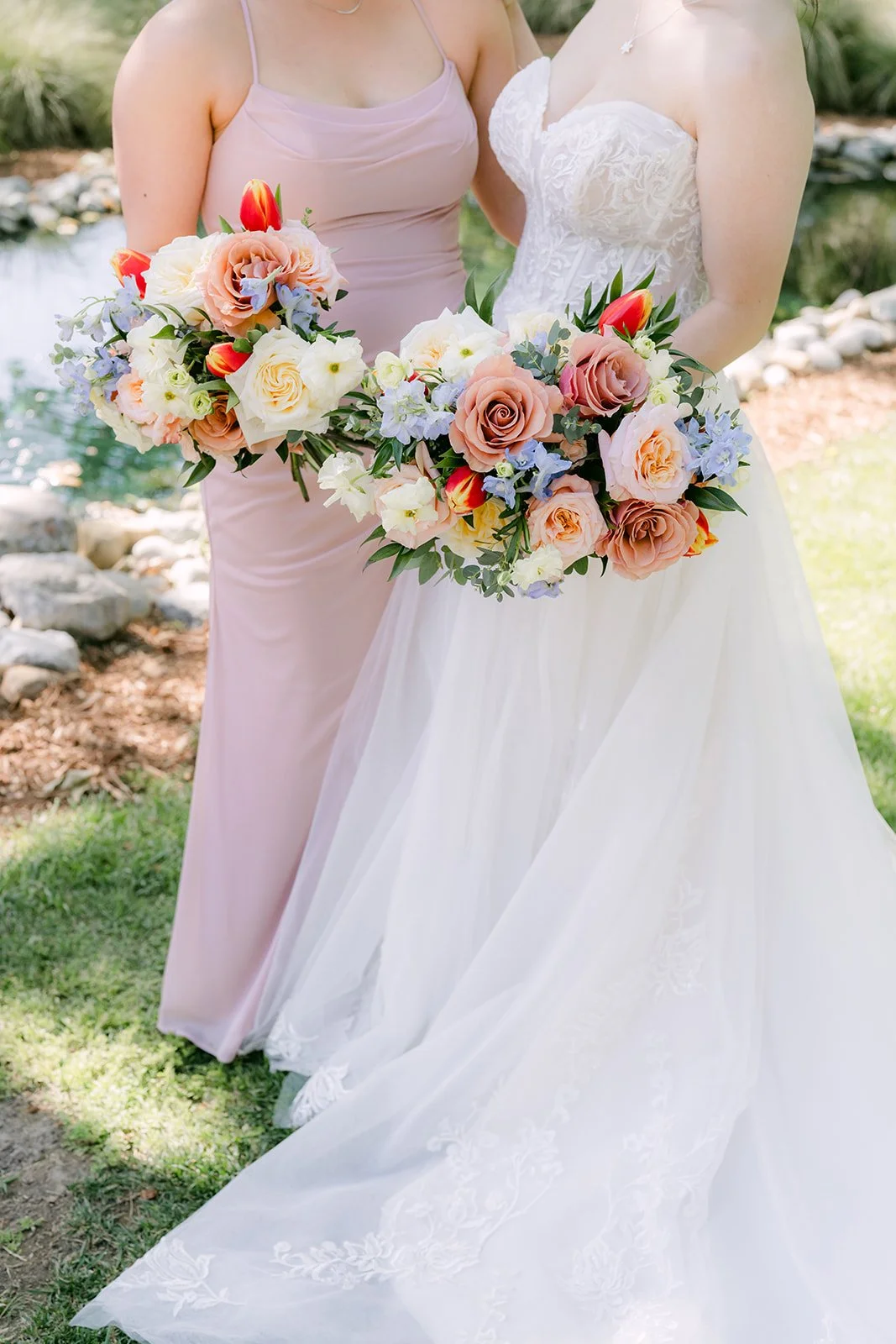 Bride and maid of honor holding their spring bouquets